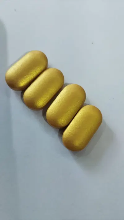 Close view of metallic gold coated caplets