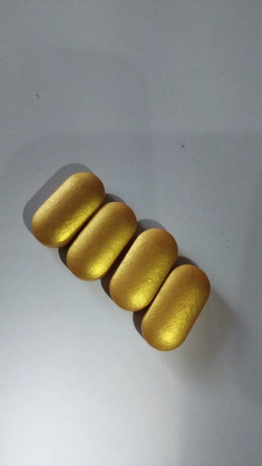 Metallic gold film coated caplets produced with Rglax Coat