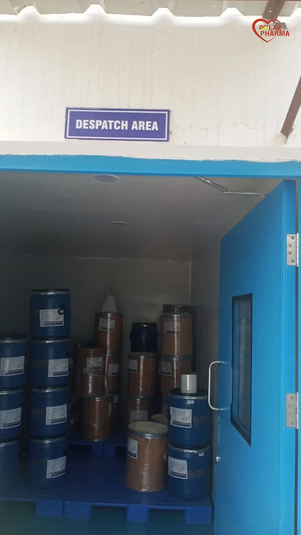 Drums of Rglax Coat material stacked on pallets in the despatch area at Tahliwal
